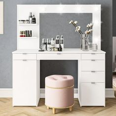 a white vanity with mirror and stool next to it in a room filled with furniture