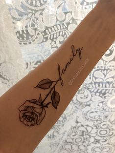 a woman's arm with a tattoo that says family and a rose on it