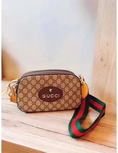 Brown GG Tiger crossbody bag with classic red and green shoulder strap, brand logo on the front and gold hardware accessories. Green and red webbing straps, oval Gucci leather label, (this item is packaged in a dust bag or box) Luxury Gucci Bag With Logo, Luxury Gucci Shoulder Bag With Logo Strap, Luxury Multicolor Gucci Shoulder Bag, Gucci Crossbody Bag Lyst, Inspired Gucci Bags, Womens Gucci Bags, Gucci Crossbody Bags For Men, Fake Gucci Handbags Herren, Gg Gucci Bag