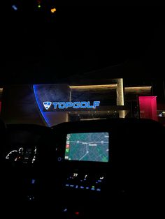 the topgolf sign is lit up at night