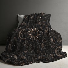 a black blanket with zodiac symbols on it