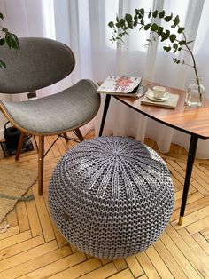 a chair and table in a room with wooden floors