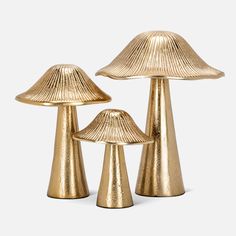 three gold - plated mushroom lamps are shown against a white background