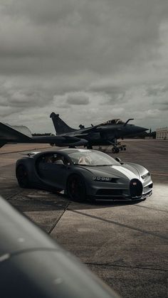 a bugatti is parked in front of an air force jet