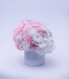 pink and white flowers in a vase on a white background with the word love written below it