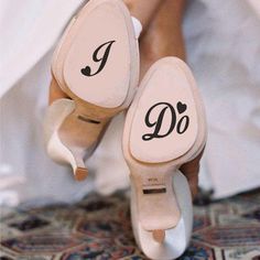 two pairs of shoes with i do written on the soles are shown in front of each other