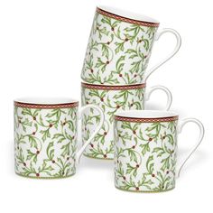 four coffee mugs with holly designs on the sides and red trimming around them