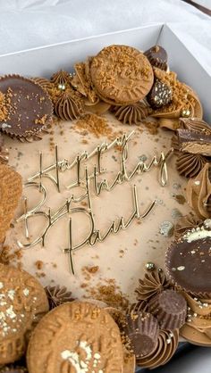 a birthday cake with cookies and frosting in a box