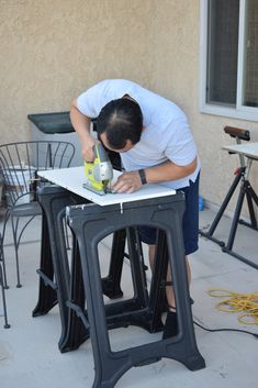 a man is working on an outdoor table