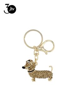 a keychain with a dog on it that is made out of gold glitter