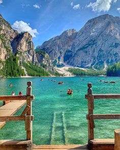 people are on boats in the water near mountains and trees, with text overlay that reads lago di braes