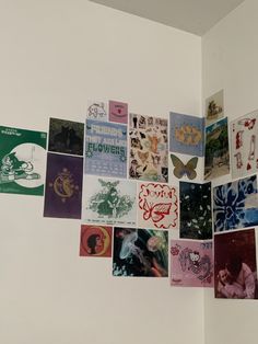 a wall with many different pictures hanging on it's side and one is upside down