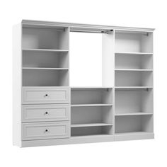 an empty white bookcase with drawers and mirror