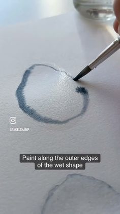 someone is using a marker to draw a heart on the paper with watercolor pencils