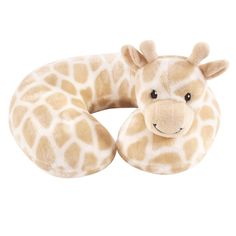 a stuffed giraffe is laying down with its head on the back of a pillow