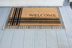 a welcome mat is on the front porch