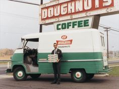 a man standing in front of a doughnut truck