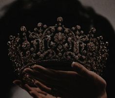 a person holding a tiara in their hands