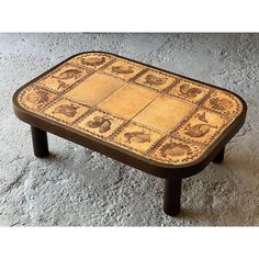 a coffee table with an animal pattern on the top and bottom, sitting on a tile floor