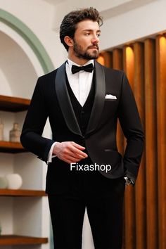 a man in a tuxedo is posing for the camera with his hands on his hips