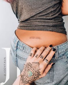 a woman's stomach with tattoos on it and the words good girl written in cursive writing