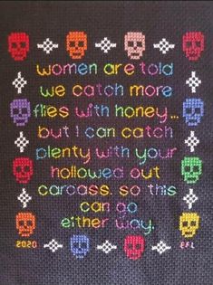 a crocheted afghan with words written in different colors and skulls on the side