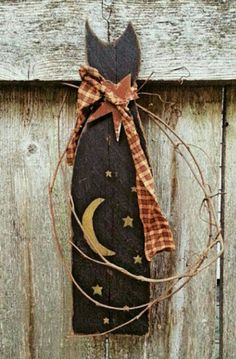 a door hanger with a cat on it and a moon hanging from the front