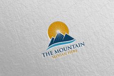 the mountain logo is shown in blue and yellow colors on a white paper background with an orange sun behind it