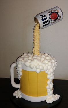 a cake made to look like a beer mug with foamy bubbles pouring from it