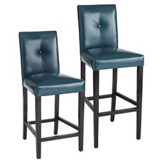 pair of blue leather bar stools with buttoned back and foot rests on white background