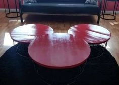 a mickey mouse coffee table sitting on top of a hard wood floor next to a couch