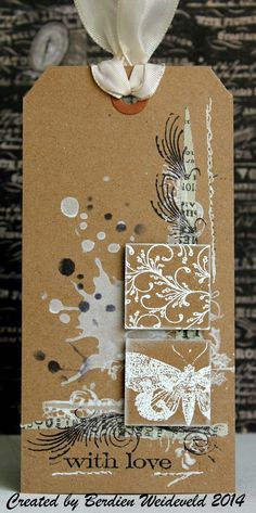 a brown tag with white flowers on it and the words with love written in black ink