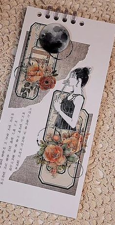 a piece of paper with an image of a woman and flowers on it, sitting on the floor