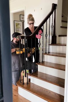 a man and woman are working on some stairs