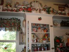 a kitchen cupboard filled with lots of dishes and cups on top of it's shelves