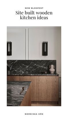 a kitchen with marble counter tops and wooden cabinets in the back drop off cabinetry