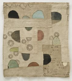 an old piece of cloth with various patches and circles on the fabric, all in different colors