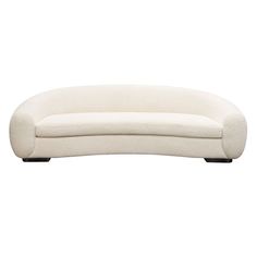 a white couch sitting on top of a wooden table