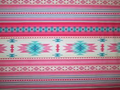 a pink and blue blanket with different designs on it