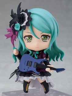 a doll with green hair holding a blue guitar and wearing a flower in her hair