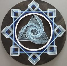 a black and blue plate with an intricate design on it's side, in the shape of a spiral