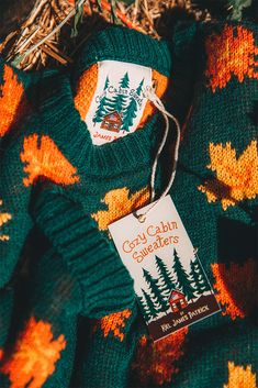 a green sweater with trees on it and a tag that says crazy cabin giveaways