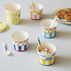 ice cream and cookies in colorful cups with spoons