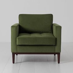 a green chair sitting on top of a white floor