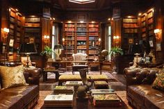 a living room filled with lots of brown furniture and bookshelves full of books