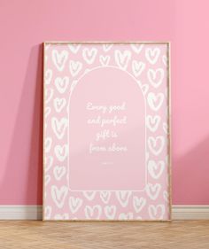 a pink and white heart pattern with a quote on the frame in front of a pink wall