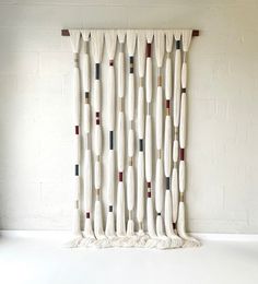 a white wall hanging on the side of a brick wall