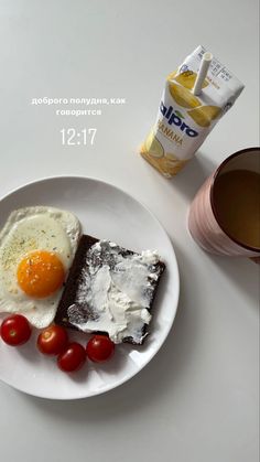 a white plate topped with two pieces of cake next to a cup of coffee and a bag of chips