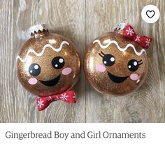 two christmas baubles with faces painted on them, one has a bow and the other has snowflakes