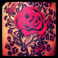 a rose tattoo on the back of a woman's upper arm and lower half